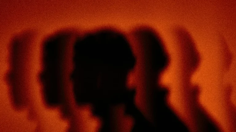 Blurred silhouettes in profile representing exposure and fear of public judgment
