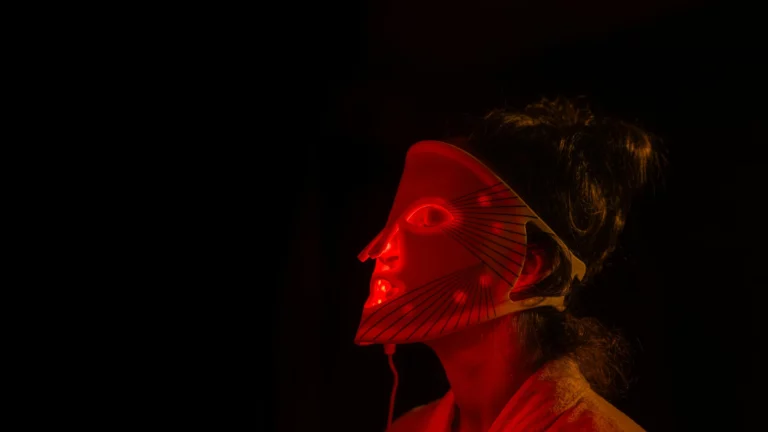 Woman’s face illuminated by red light
